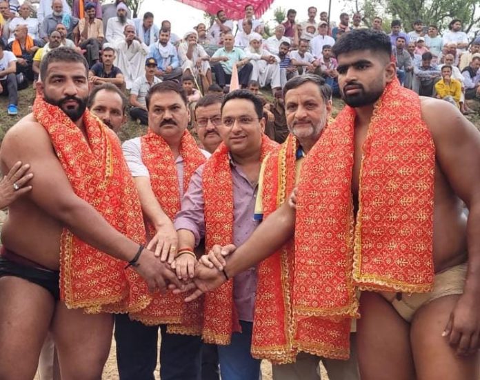 Dignitaries posing along with wrestlers during a dangal event at Reasi. Dignitaries posing along with wrestlers during a dangal event at Reasi.
