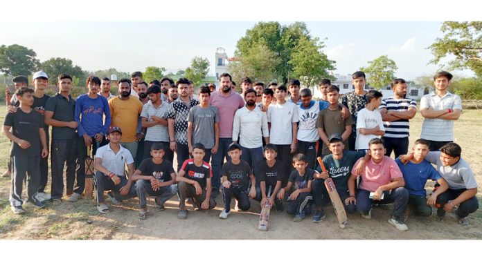 Young players posing with organisers during a cricket tournament. Young players posing with organisers during a cricket tournament.