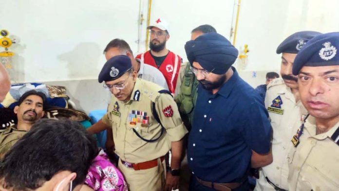ADGP Jammu Anand Jain interacting with an injured cop at GMC Doda on Thursday.
