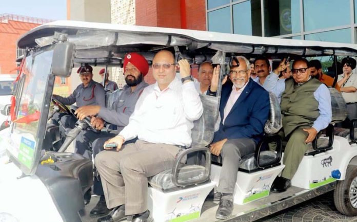 Officials of AIIMS Jammu taking a ride in an electric vehicle donated to the institution by J&K Bank. Officials of AIIMS Jammu taking a ride in an electric vehicle donated to the institution by J&K Bank.