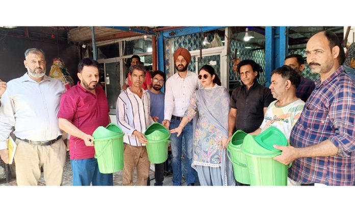 JMC team distributing dustbins during surprise inspection of meat shops in Jammu. JMC team distributing dustbins during surprise inspection of meat shops in Jammu.