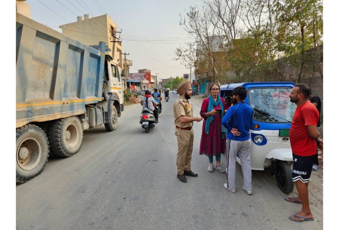 Officials of the Motor Vehicle Department checking traffic violations during a drive launched in Jammu on Tuesday.