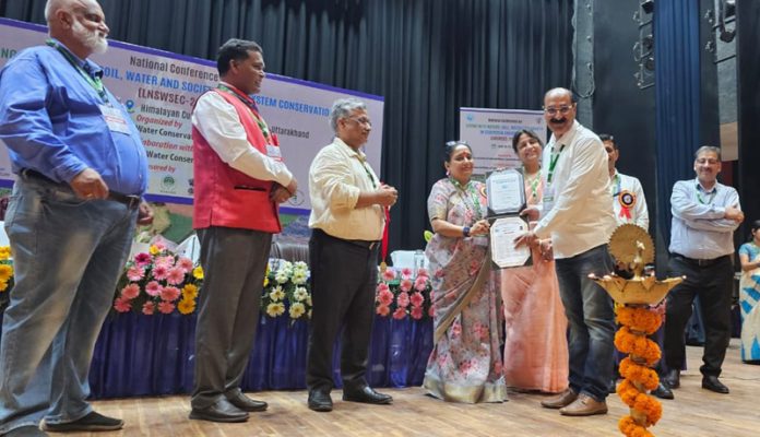 Chowdhury Mohammad Iqbal, Director Agriculture, Kashmir receiving an award in Dehradun on Thursday.