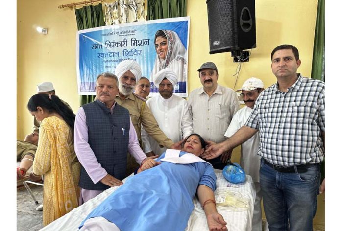 A volunteer donating blood at a camp in Jammu on Sunday.