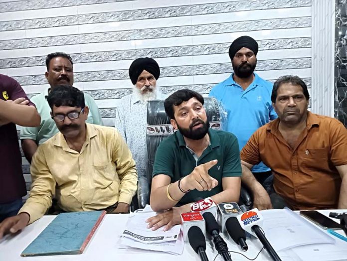 Maxi Cab & Special Taxi Operators Union president, Vijay Dogra talking to media-persons at Narwal in Jammu. -Excelsior/Rakesh