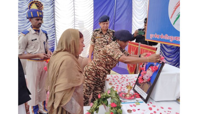 CRPF personnel garlanding portrait of martyr at Bhaderwah on Thursday. -Excelsior/Tilak Raj