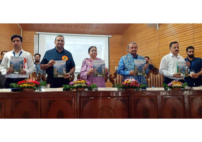KU Vice-Chancellor and others releasing souvenir during inaugural of Intl conference on biodiversity.