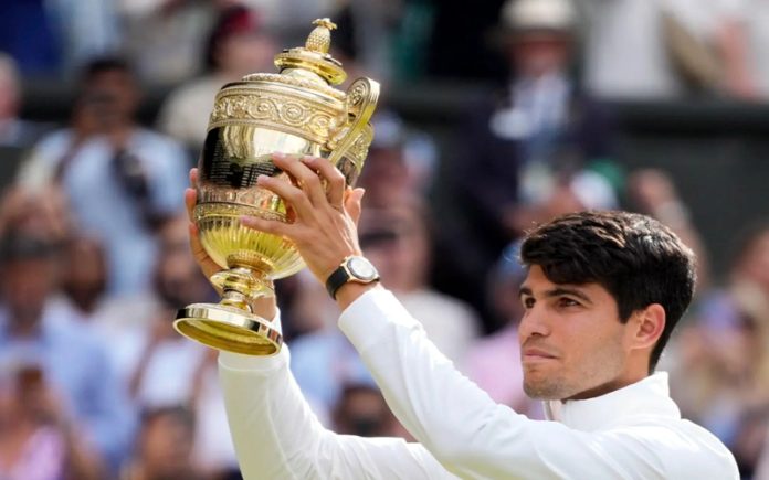 Carlos Alcaraz holding trophy after defeating Novak Djokovic in the Wimbledon men’s singles final in London on Sunday. Carlos Alcaraz holding trophy after defeating Novak Djokovic in the Wimbledon men’s singles final in London on Sunday.