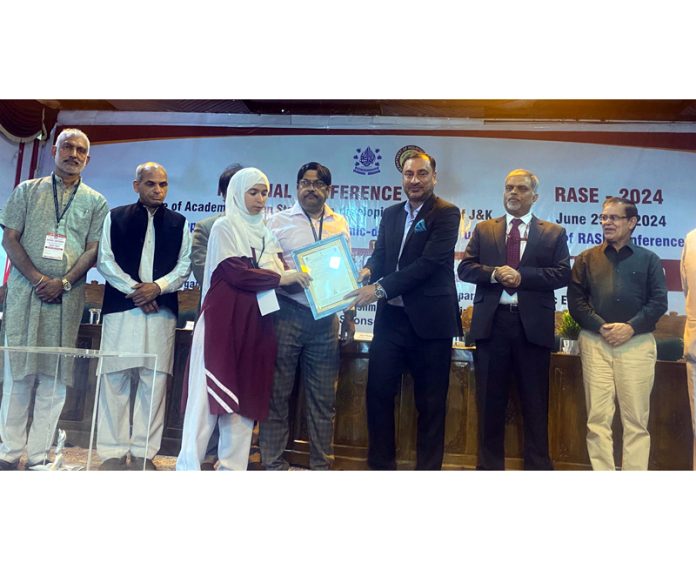 A student being awarded certificate by a dignitary during a conference held at NIT Hazratbal, Srinagar.