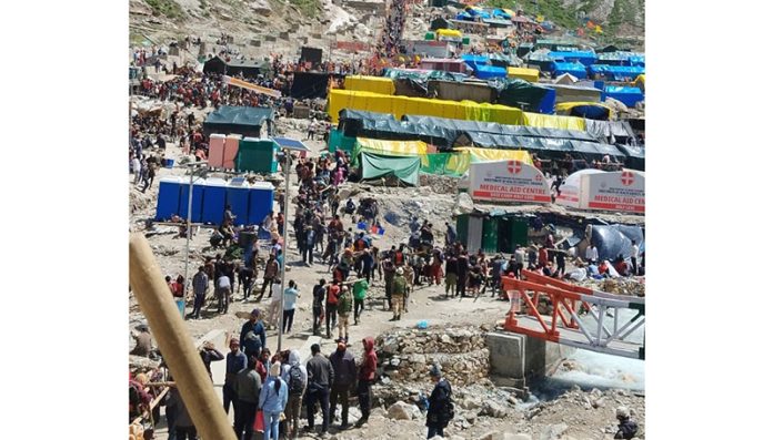Yatris waiting near holy cave for darshan on Sunday. Yatris waiting near holy cave for darshan on Sunday.