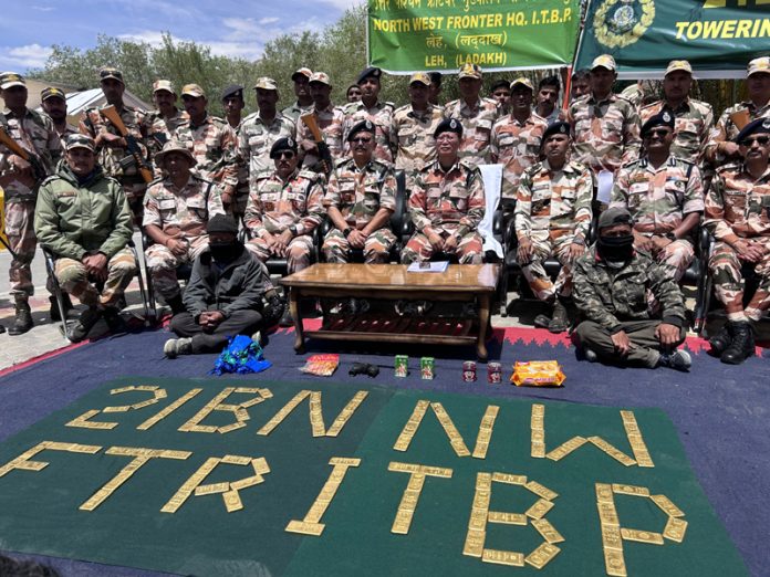 ITBP jawans with seized gold and other items in Leh on Wednesday.