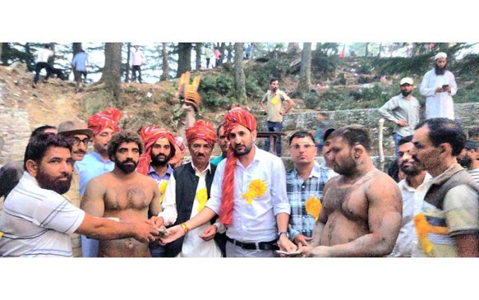 Wrestlers being introduced before the main bout at Bani by dignitaries.