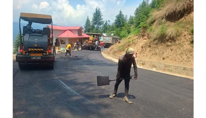 BRO personnel busy in blacktopping Bhadarwah-Jaie road on Sunday.