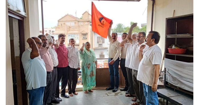 BMS members hoist flag during the celebration of 70th foundation day in Jammu on Tuesday.