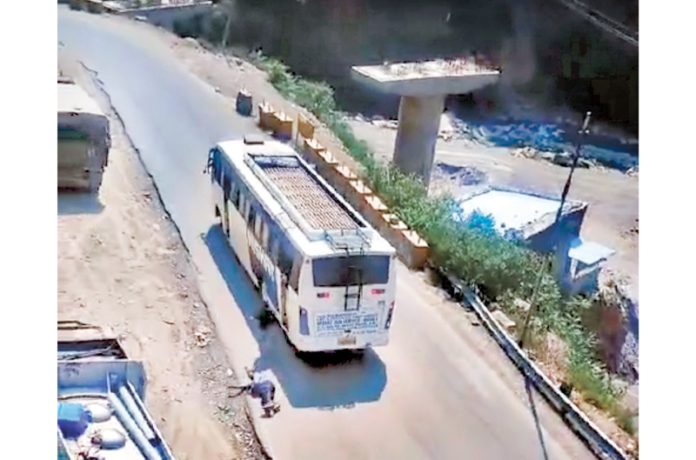 A passenger falls on road after jumping from out of control bus in Nachlana area of Ramsu on Tuesday. A passenger falls on road after jumping from out of control bus in Nachlana area of Ramsu on Tuesday.