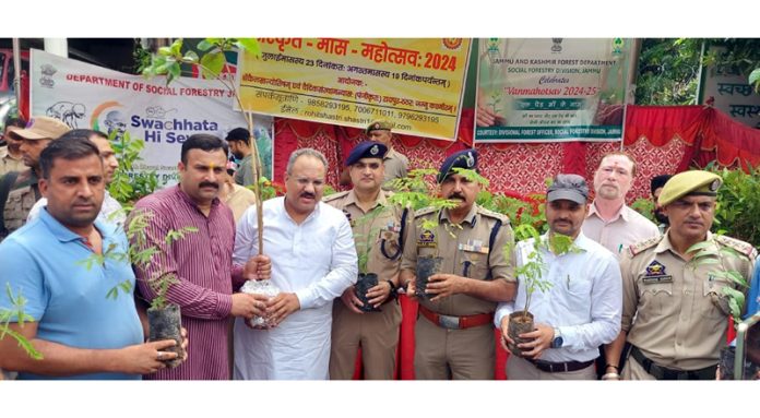 Dignitaries distributing plants on the start of Sanskrit Month in Jammu on Tuesday.