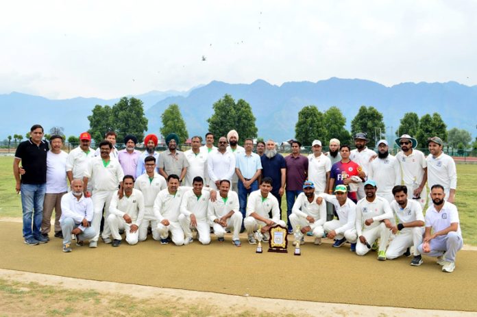 Winning team posing along with trophy at Srinagar on Friday.