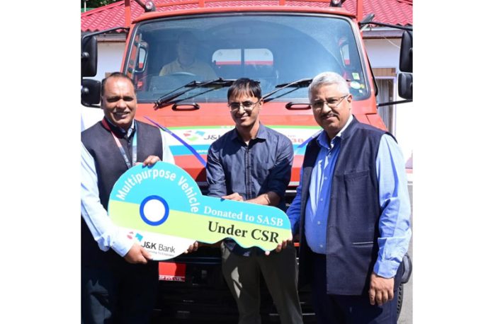J&K Bank MD and CEO, Baldev Prakash, handing over the keys of a multi-purpose vehicle to SASB CEO, Dr Mandeep K Bhandari, at Raj Bhawan in Srinagar on Thursday. J&K Bank MD and CEO, Baldev Prakash, handing over the keys of a multi-purpose vehicle to SASB CEO, Dr Mandeep K Bhandari, at Raj Bhawan in Srinagar on Thursday.
