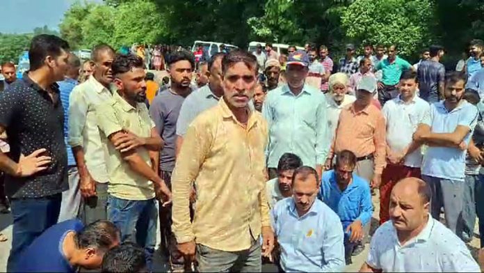 Relatives of minor boy and villagers protesting on Jammu-Rajouri highway at Kaller Chowk on Sunday. -Excelsior/Imran