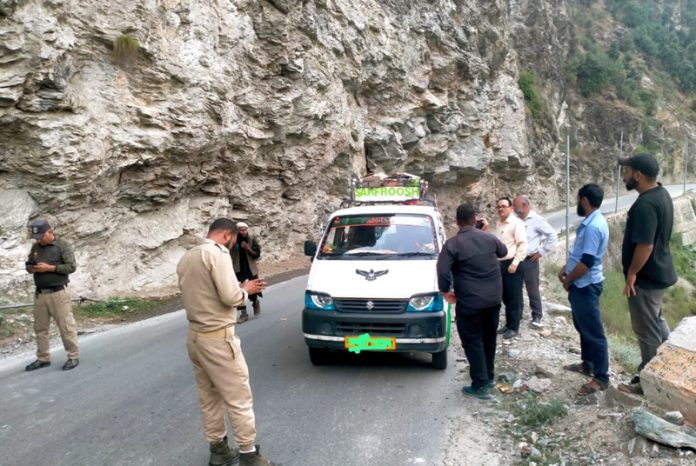 Traffic authorities in Kishtwar checking a vehicle for violations.