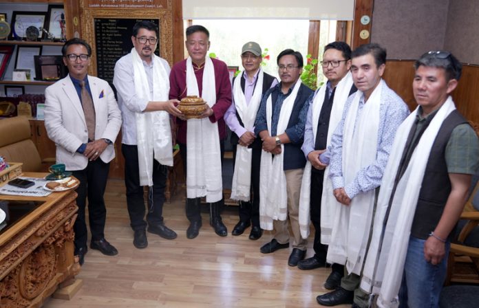 CEC Tashi Gyalson posing along with others during a programme held in Leh on Monday.