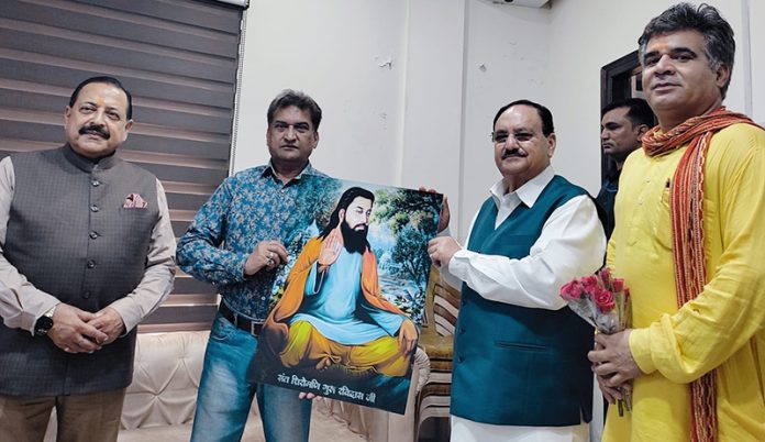 BJP leader Balbir Ram Rattan presenting portrait of Guru Ravi Dass to BJP national president and Union Minister, J P Nadda at Jammu on Sunday.