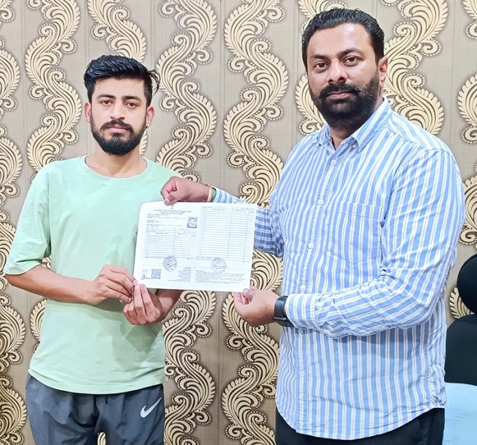 Keshav Chopra providing ration card to a local. Keshav Chopra providing ration card to a local.