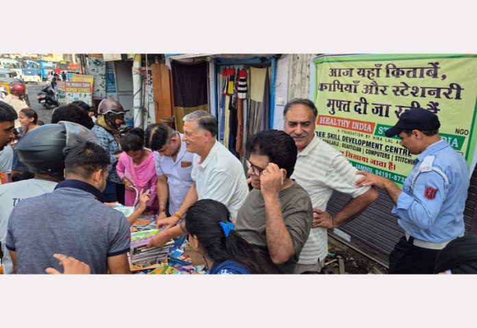 Hira Lal Abrol distributing free books and stationery items to needy students during a camp. Hira Lal Abrol distributing free books and stationery items to needy students during a camp.