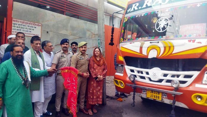 Trustees & police officials flagging off bus to Haridwar.