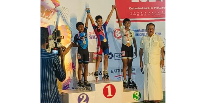 Jodhamal student Tabish Haider posing on podium during medal distribution ceremony.