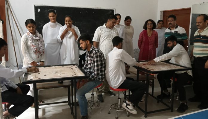 Students of GDC Marheen's Department of Physical Education participating in the Carrom competition.