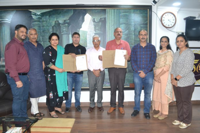 JU Registrar and Nodal officer SVEEP displaying copies of MoU signed for electoral awareness. JU Registrar and Nodal officer SVEEP displaying copies of MoU signed for electoral awareness.