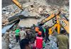 The rescue teams evacuating injured persons from the debris of a house that collapsed in Kabaddi Nallah area of Kargil district on Saturday. -Excelsior/Basharat Ladakhi