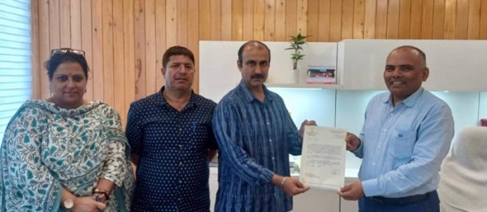 Ranjeet Kalra receiving appointment letter from Chief Electoral Officer of J&K, Pandurang K. Pole.