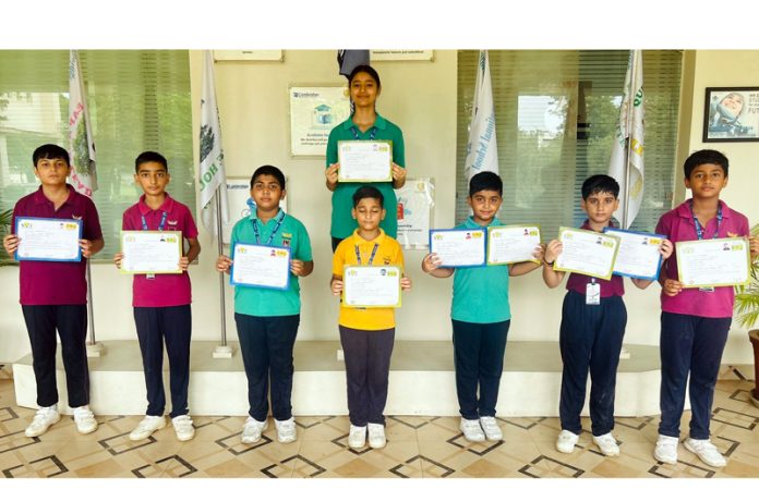 Cambridge students posing with certificates during special assembly. 