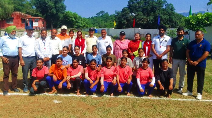 Dignitaries posing along with young girls at Pouni.
