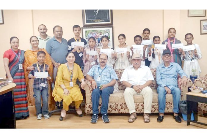 Students pose for photograph after getting scholarships from Harbans Roshan Bhalla Educational Foundation on Tuesday.
