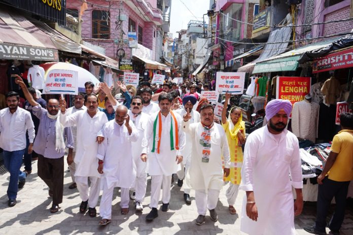 Cong leaders and workers taking out protest march in Bishnah town in Jammu district on Tuesday.