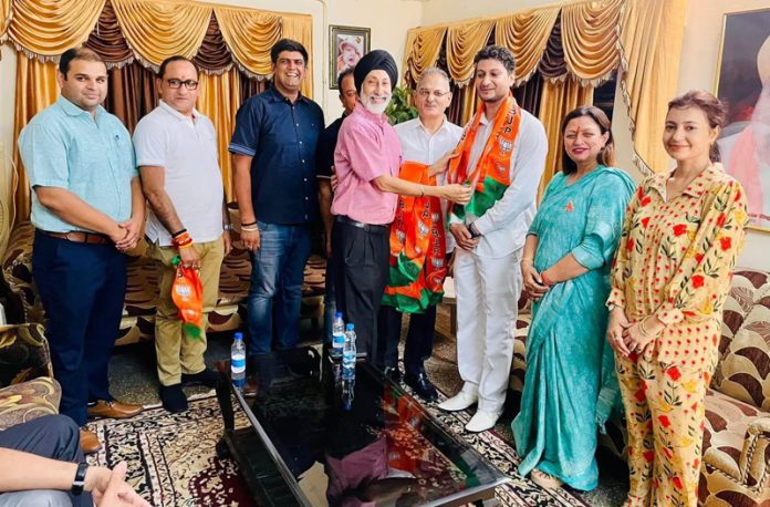 BJP leaders taking new entrants into party fold at Jammu on Tuesday. BJP leaders taking new entrants into party fold at Jammu on Tuesday.