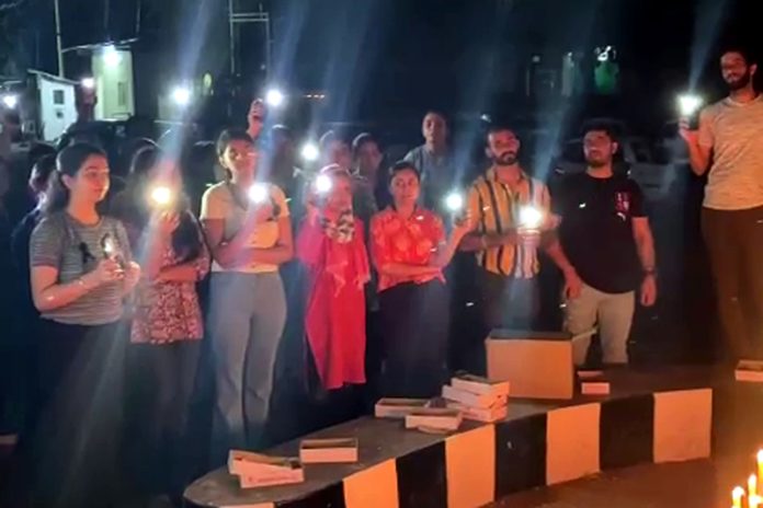 Resident doctors of GMC Jammu during a candle light protest in the College premises on Sunday evening.