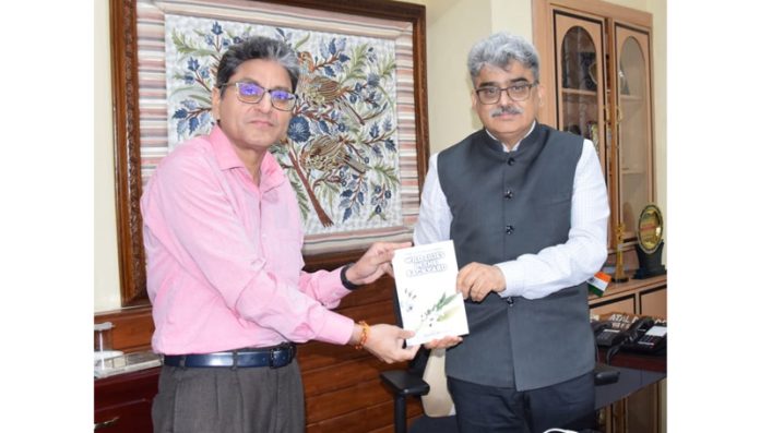 Author Vishal Sharma presenting his maiden book to CS Atal Dulloo on Thursday. Author Vishal Sharma presenting his maiden book to CS Atal Dulloo on Thursday.