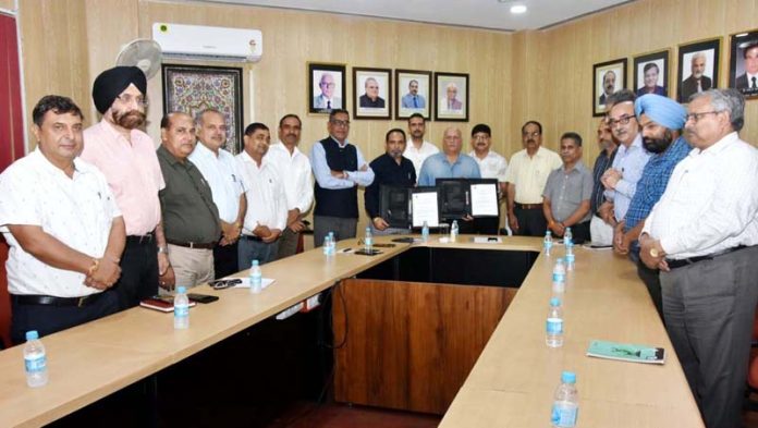 SKUAST-J Registrar and Marketing Head Bayer Crop Science displaying copies of MoU. SKUAST-J Registrar and Marketing Head Bayer Crop Science displaying copies of MoU.