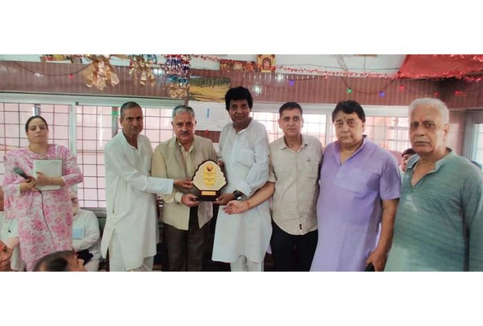 Former VC, CUJ, Prof Ashok Aima being presented an award by Pt Prem Nath Shastri Sanskritik Shodh Sansthan at Jammu on Wednesday.
