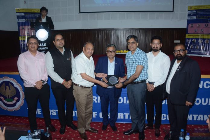 Sanjay Kumar Agarwal, Central Council Member of ICAI, receiving a memento during a conference of CAs in Jammu.