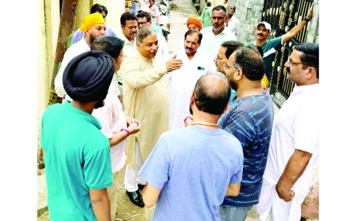 Sat Sharma, former J&K BJP President interacting with the people in Canal Road area of Jammu on Monday. Sat Sharma, former J&K BJP President interacting with the people in Canal Road area of Jammu on Monday.