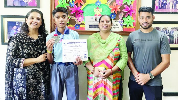 A student, Divam Kumar posing along with school management of Lawrence School. A student, Divam Kumar posing along with school management of Lawrence School.