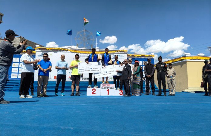 Winners posing on podium along with medals and cheques during Ladakh Marathon. Winners posing on podium along with medals and cheques during Ladakh Marathon.