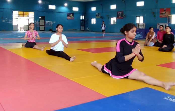 Athletes performing Yoga during District Level Inter-School Tournament at Udhampur. Athletes performing Yoga during District Level Inter-School Tournament at Udhampur.