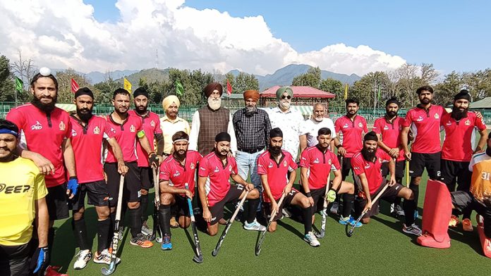 Dignitaries posing for group photograph with hockey players at Srinagar. Dignitaries posing for group photograph with hockey players at Srinagar.