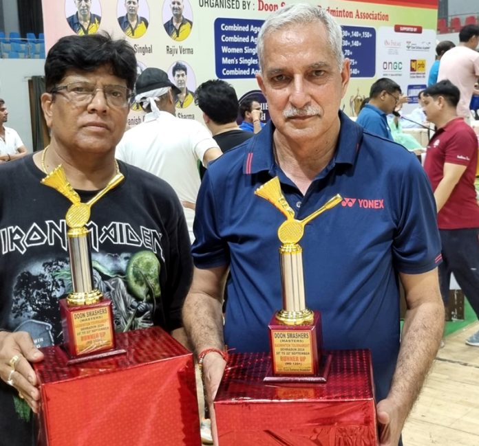 Romesh Sharma with his partner displaying trophies. Romesh Sharma with his partner displaying trophies.